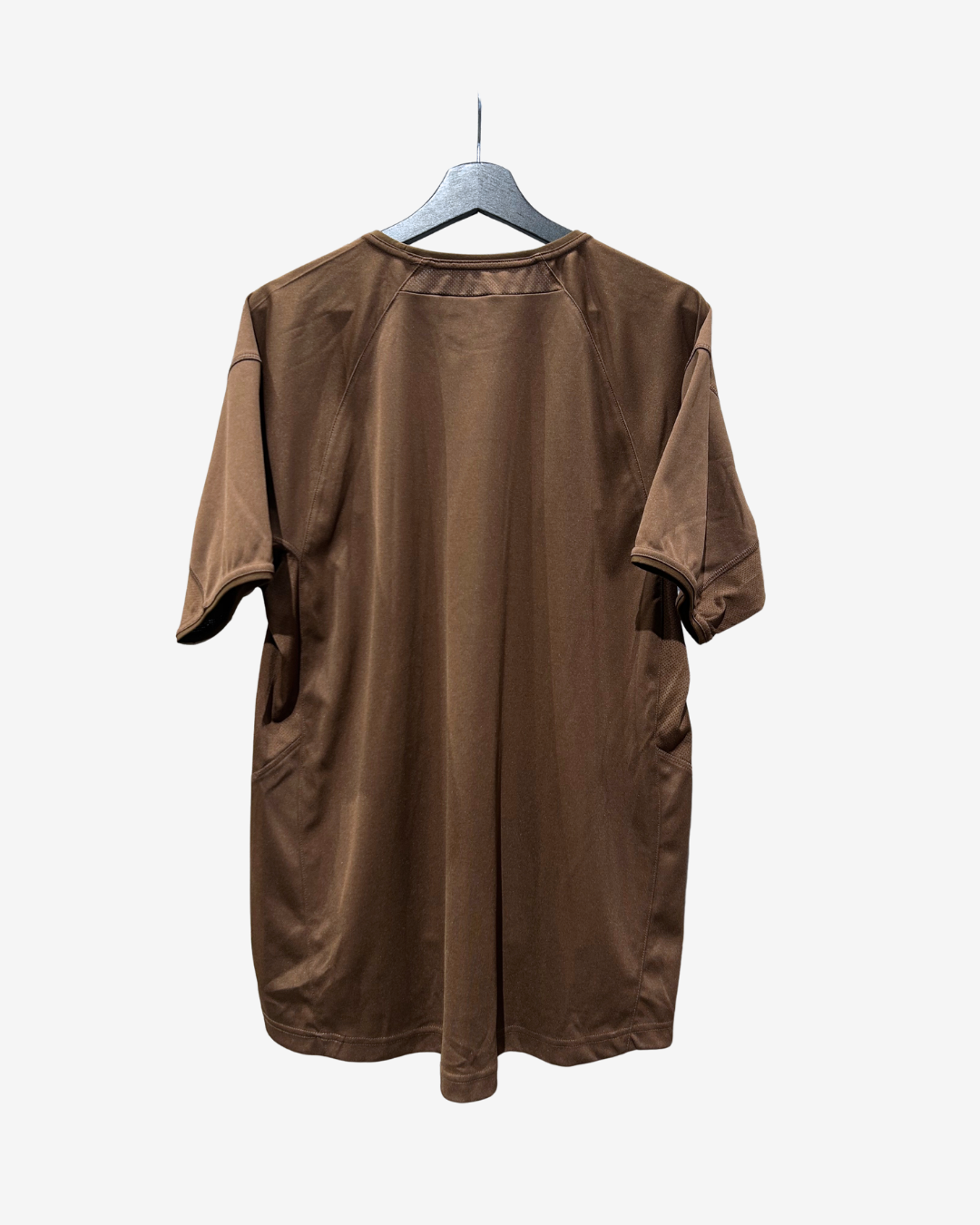 A brown short-sleeve t-shirt dress with side pockets, hanging on a gray hanger against a light gray background.