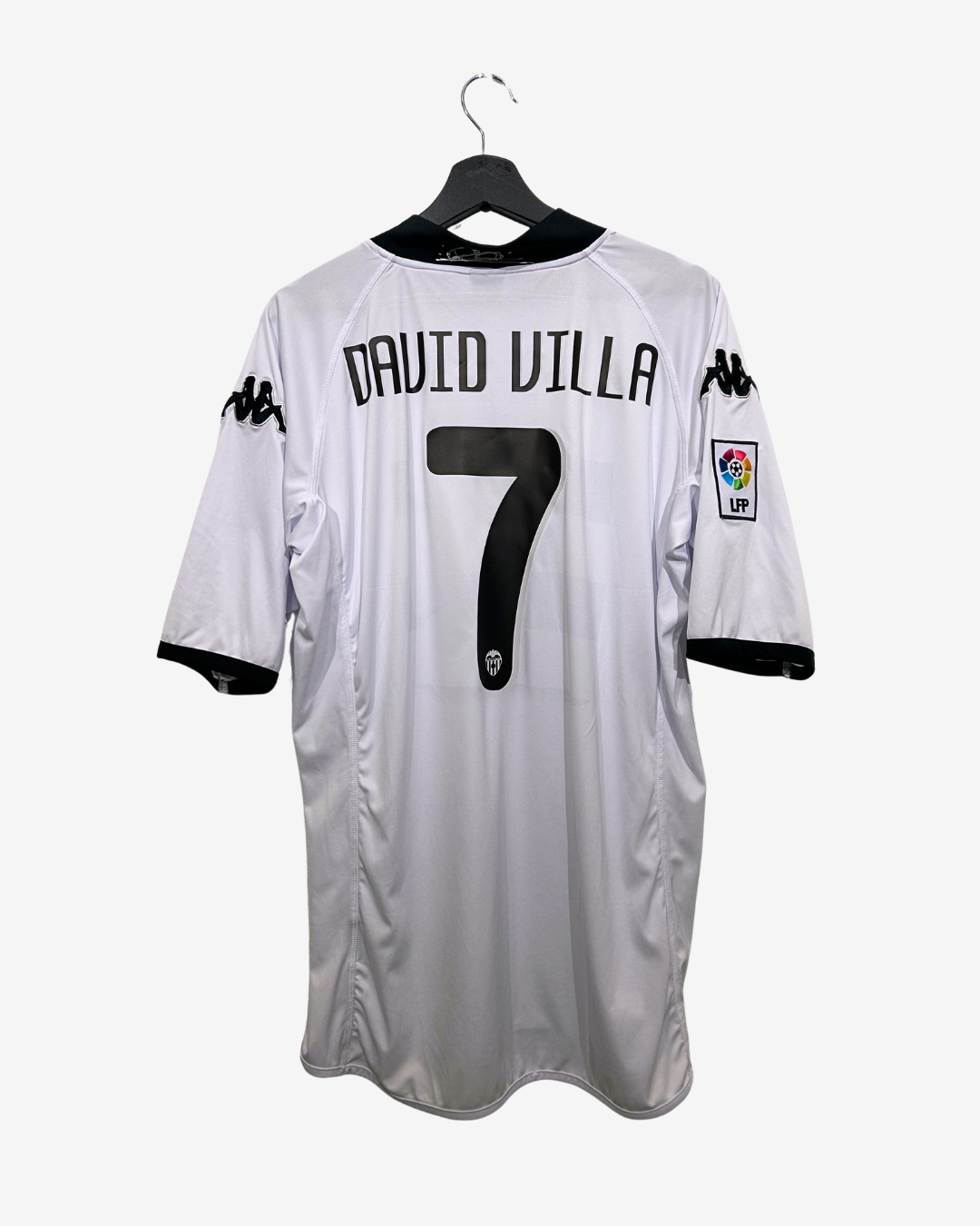 White soccer jersey with 'David Villa' and number '7' on a hanger against a white background