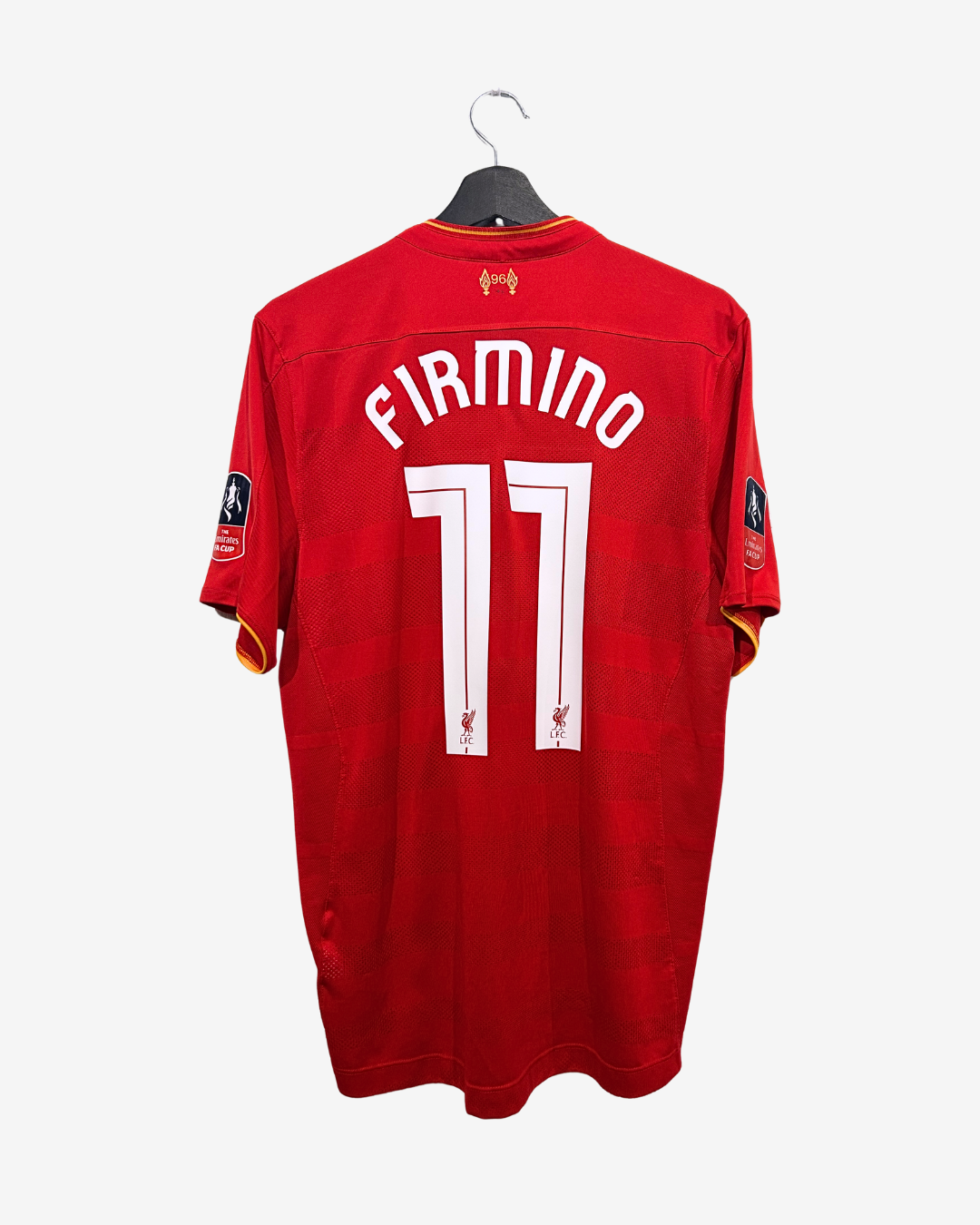 Red sports jersey with 'Firmino' and number '11' on a hanger against a white background