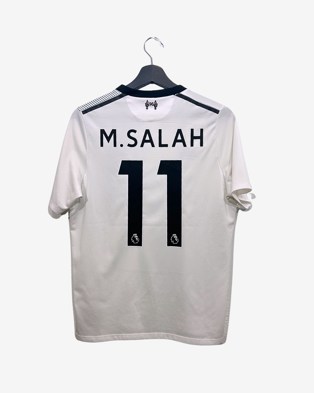 White sports jersey with 'M. Salah' and number '11' on a hanger against a white background