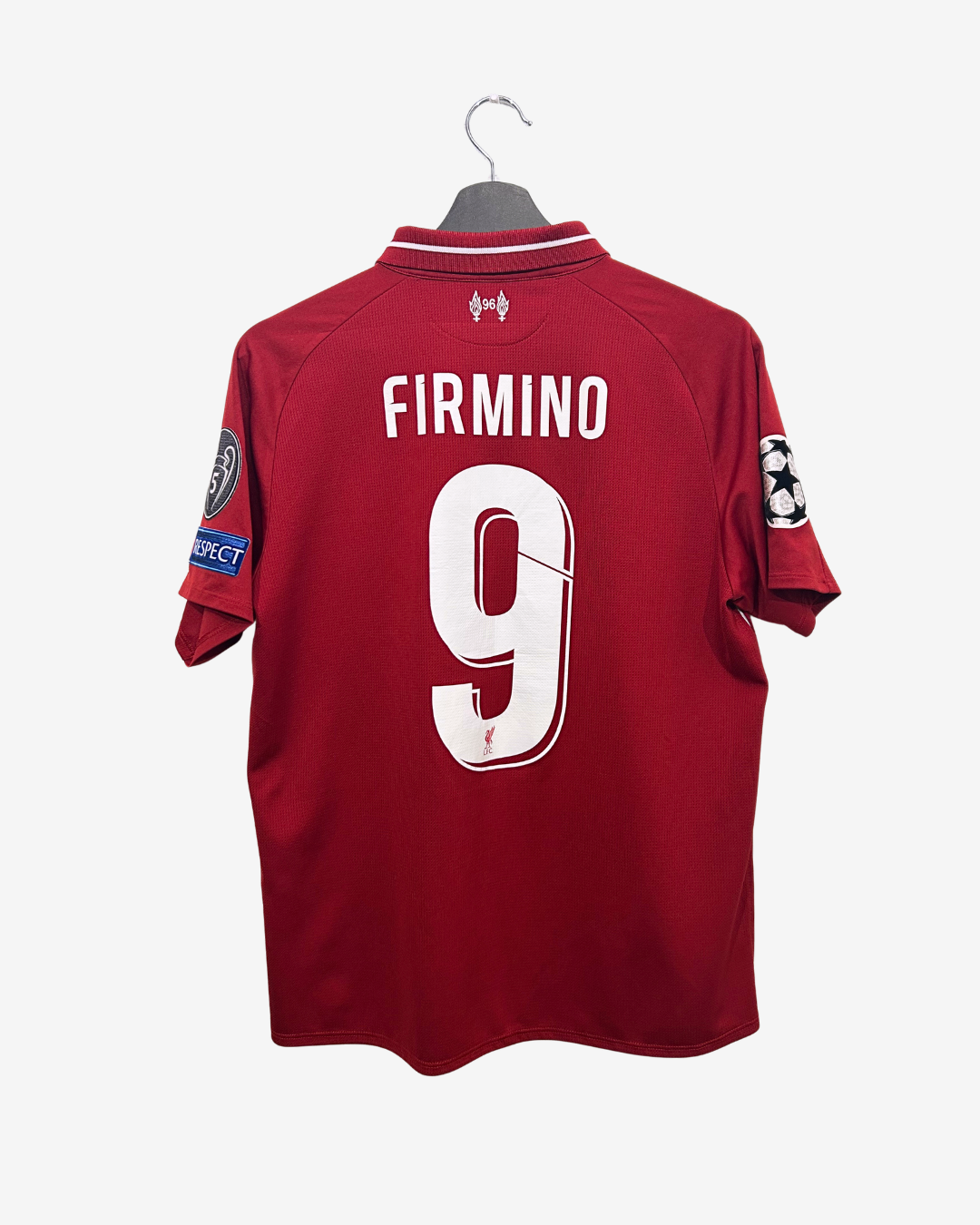 Red sports jersey with 'FIRMINO 9' on a hanger against a white background