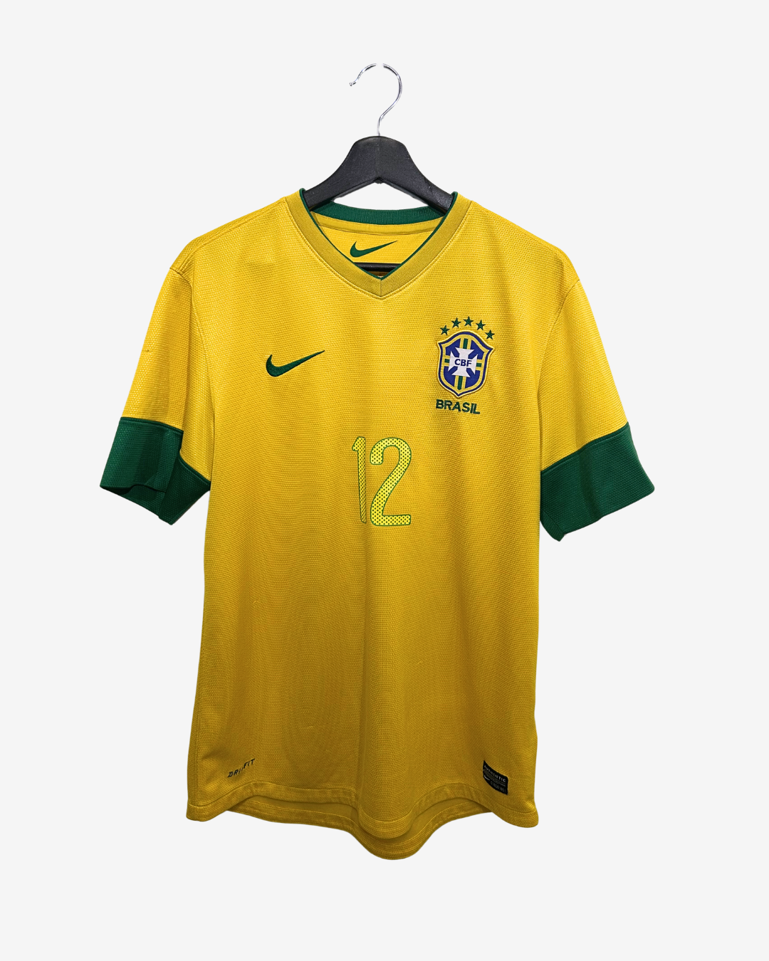Yellow soccer jersey with green sleeves on a hanger against a white background