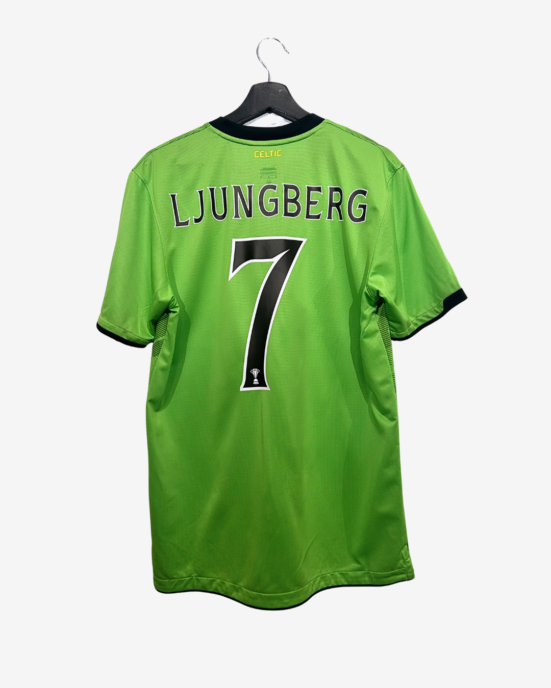 Green sports jersey with 'LJUNGBERG' and number '7' on a hanger against a white background