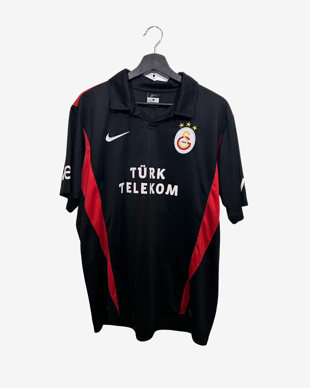 Black sports jersey with red accents on a hanger against a white background