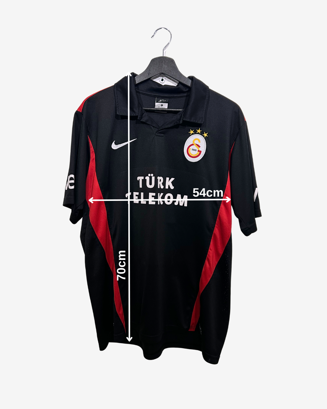Black sports jersey with red accents on a hanger, featuring Turkish Telekom branding.