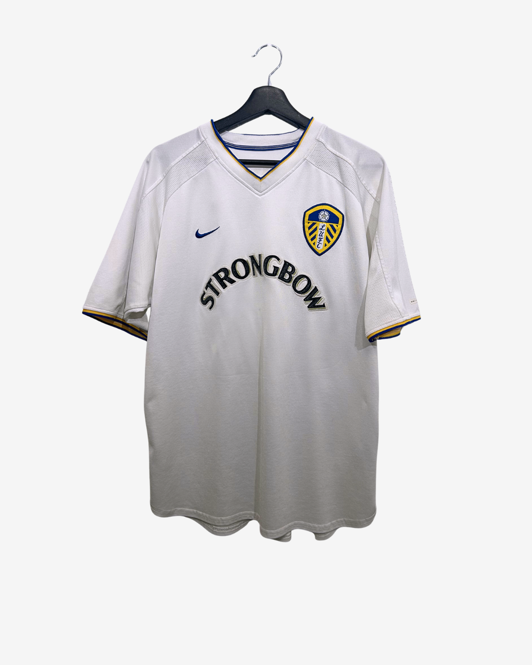White sports jersey with branding on a hanger against a white background