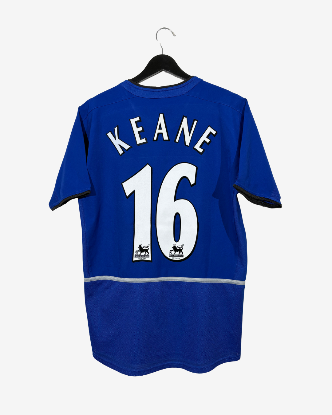 A royal blue short-sleeve soccer jersey hanging on a black hanger against a light gray background. The back of the shirt features the name 'KEANE' in white arched letters above the number '16' in large white block digits with black outlines.