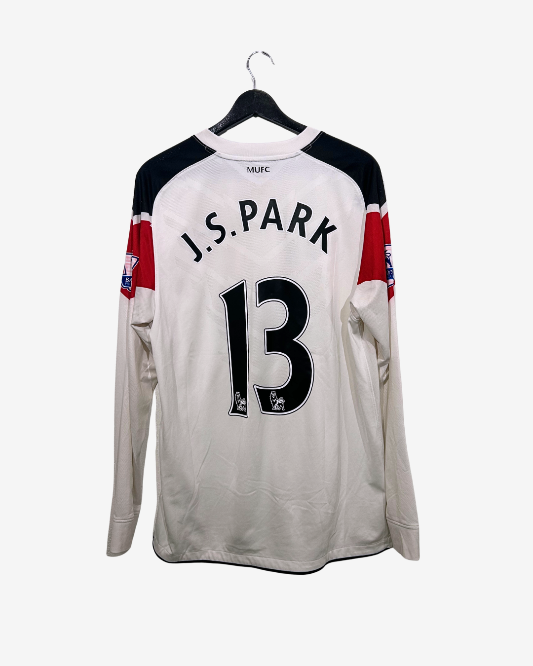 White sports jersey with black and red accents, featuring the name 'J.S.