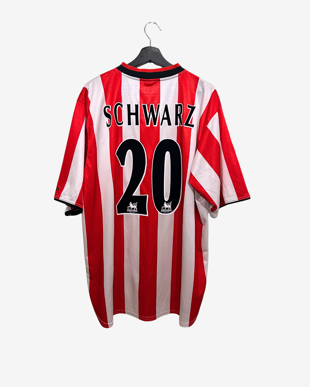 Red and white striped sports jersey with 'Schwarz' and number '20' on a hanger against a white background