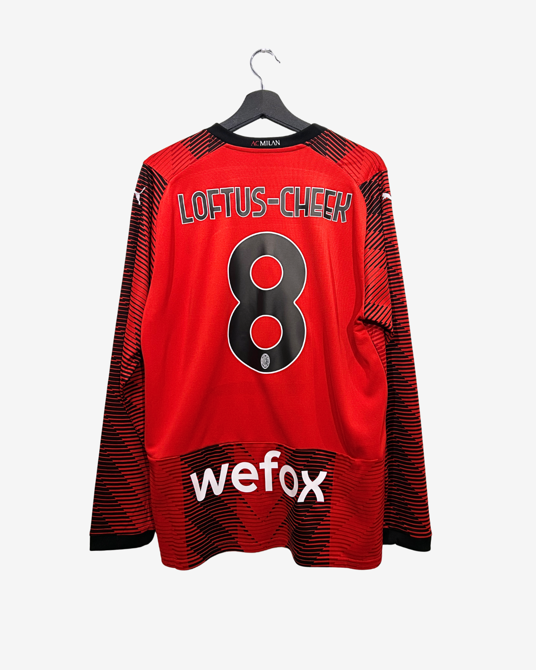 Red sports jersey with black accents, featuring the name 'Loftus-Cheek' and number '8', on a hanger against a white background.