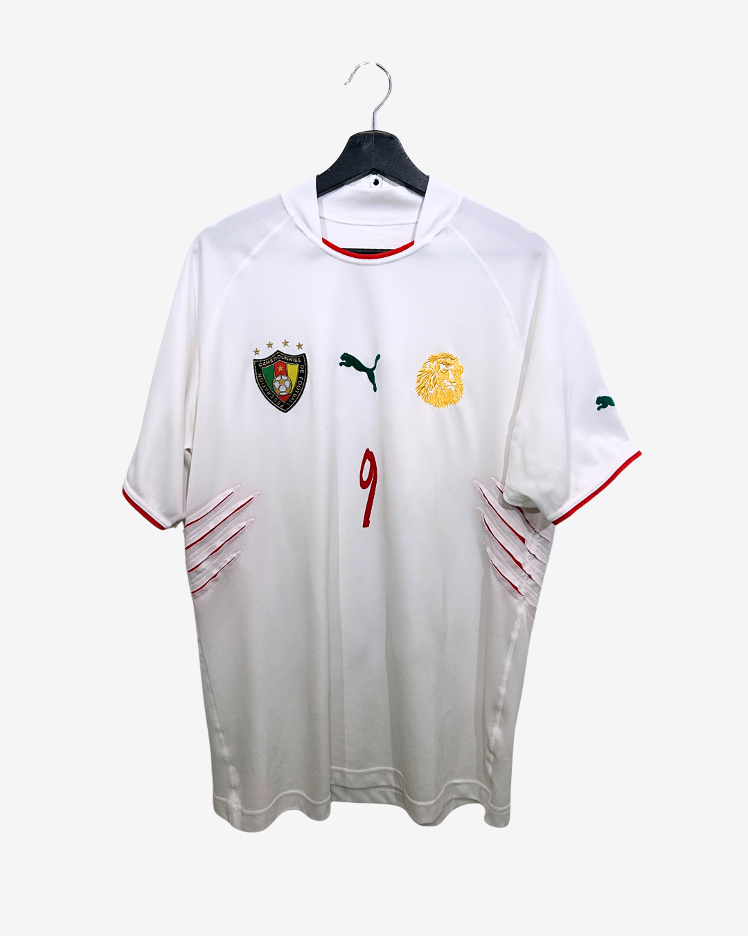 White sports jersey with red and black accents on a hanger against a white background