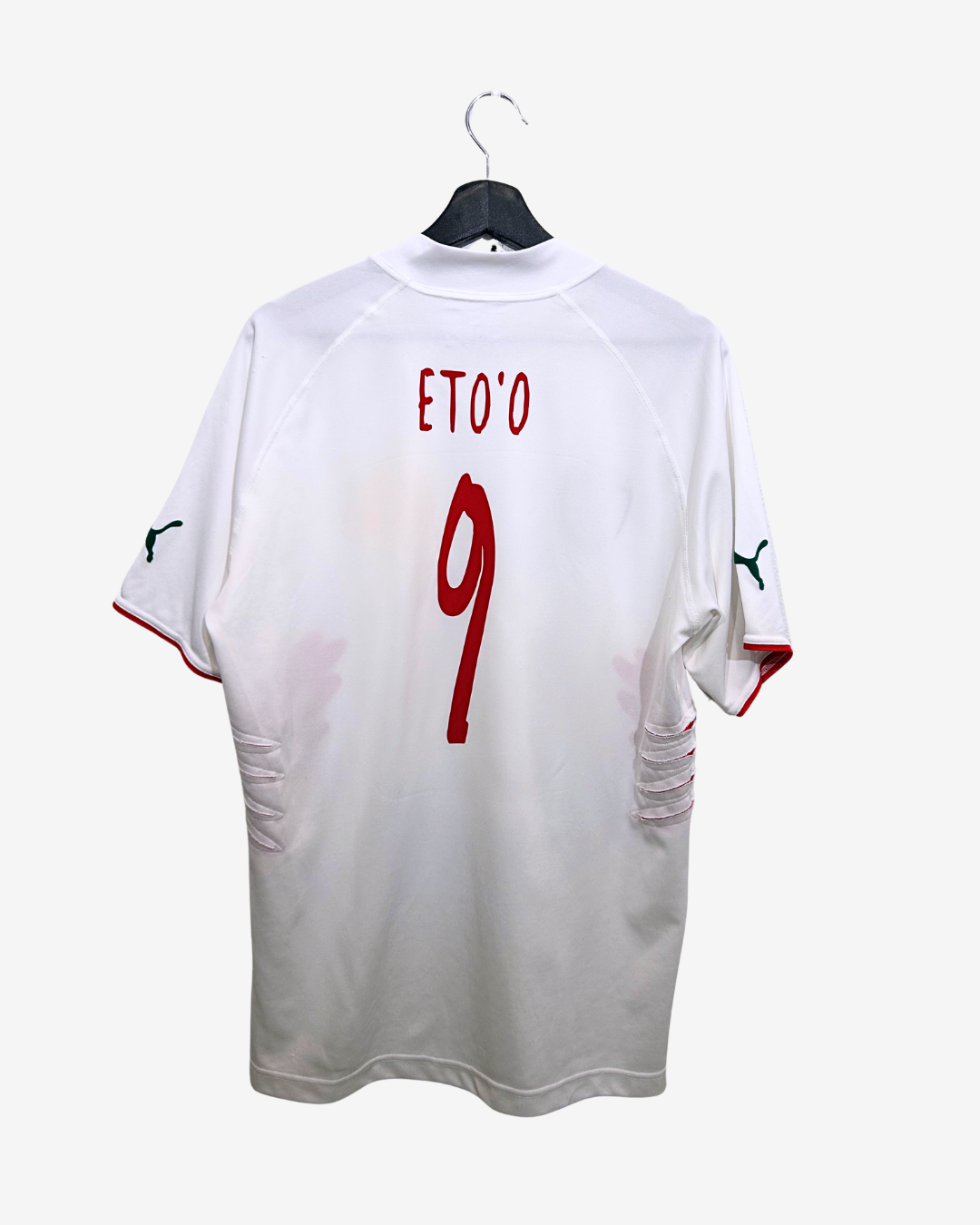 White sports jersey with 'Eto'o' and number '9' on a hanger against a white background