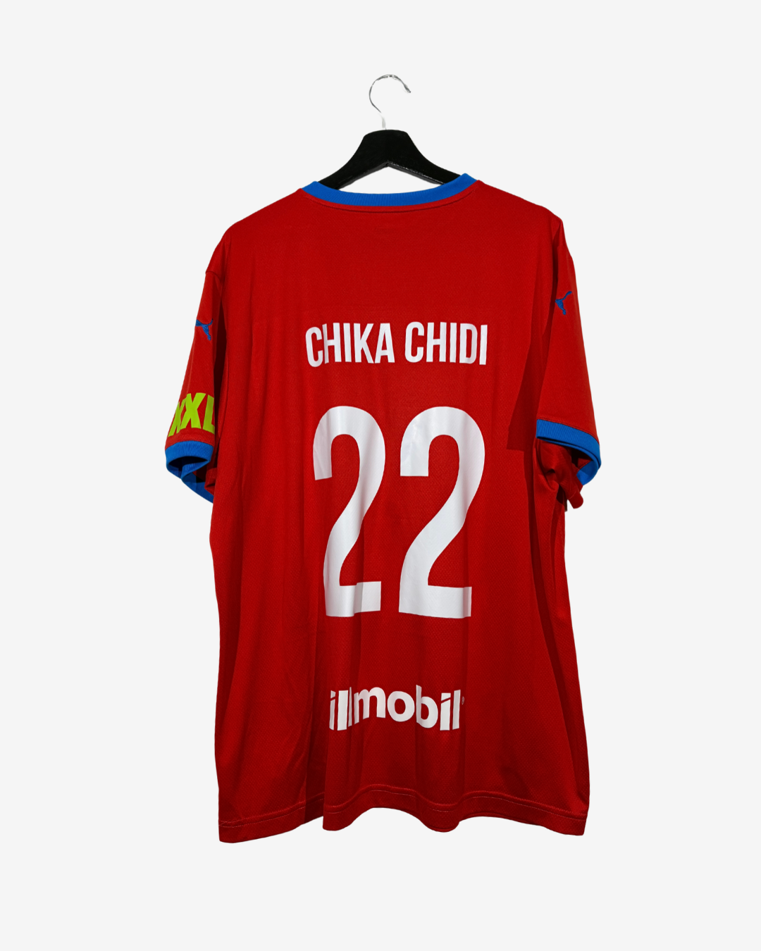 A red soccer jersey with 'CHIKA CHIDI 22' printed on the back, hanging on a black hanger against a light gray background.