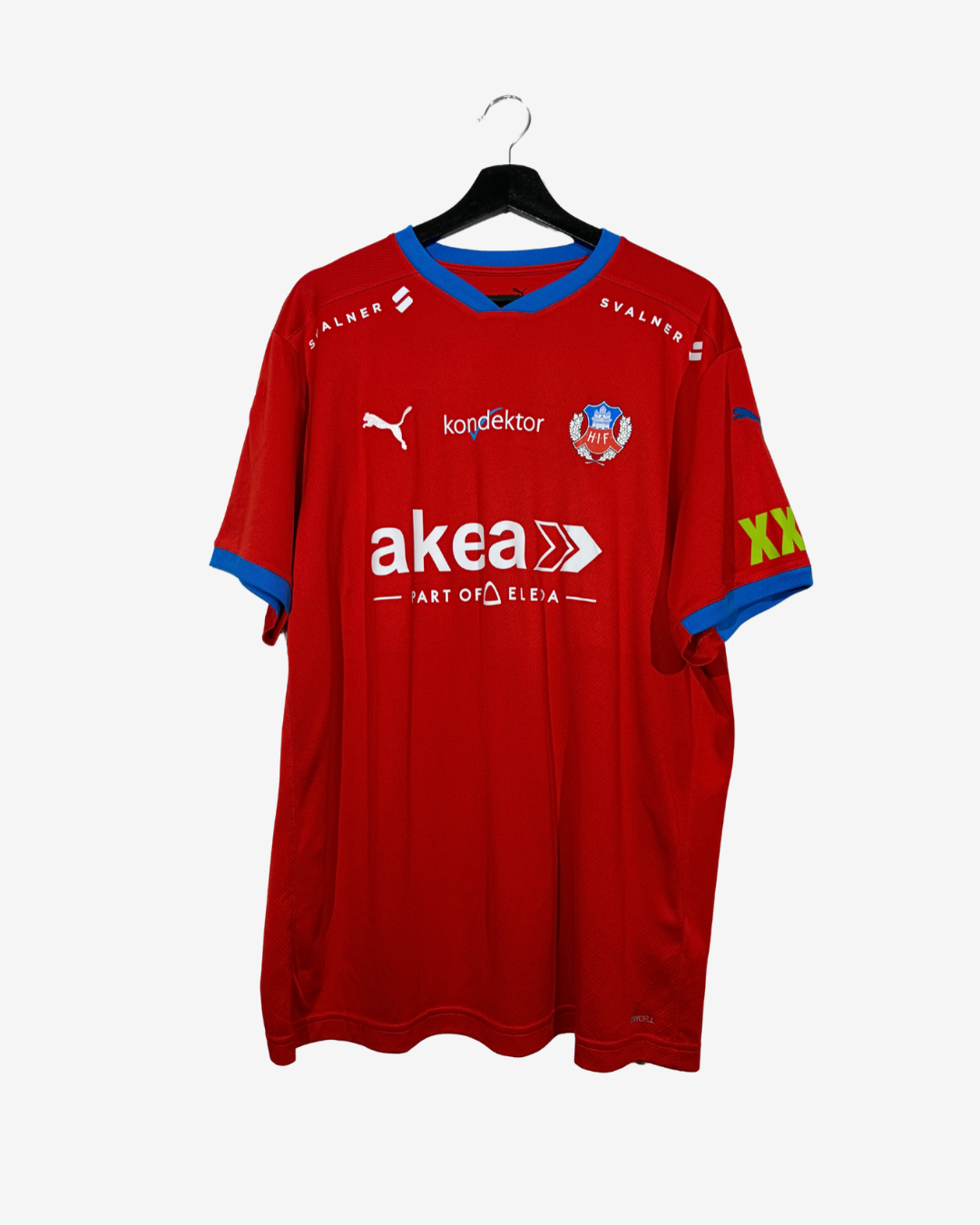 A red Swedish football jersey with blue trim, featuring Puma branding, the Swedish Football Association crest, and sponsor logos including Akea and konféktor, hanging on a black hanger against a light gray background.