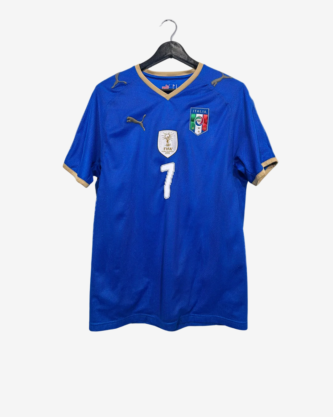 Blue sports jersey with number 7 on a hanger against a white background