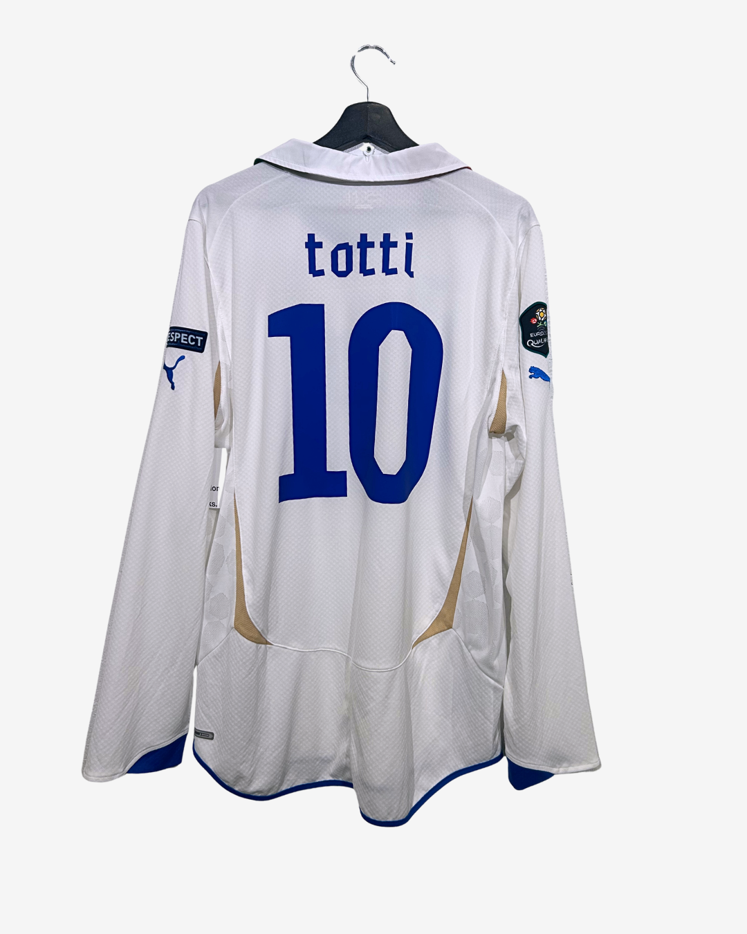 White sports jersey with 'totti' and number '10' on a hanger against a white background