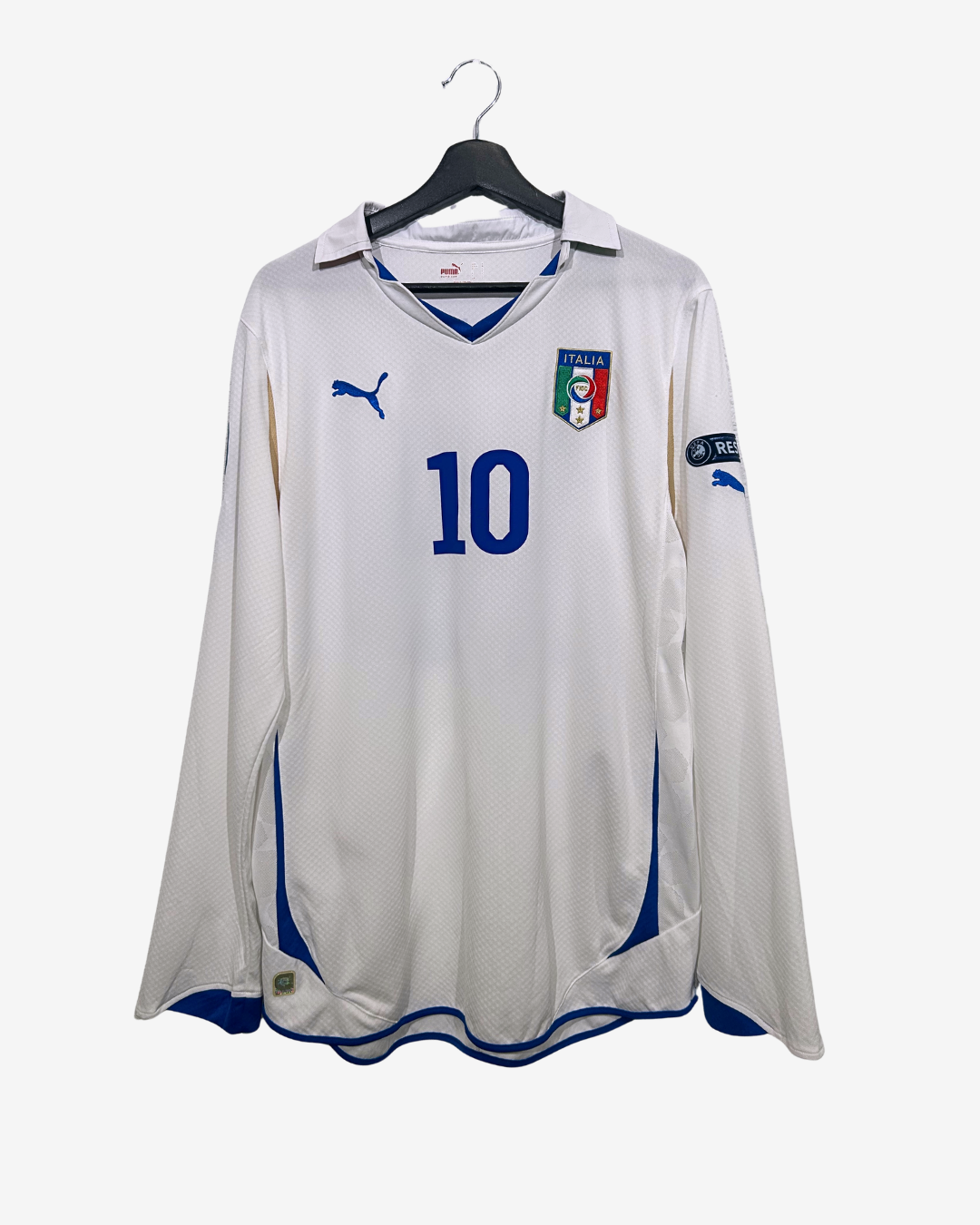 White soccer jersey with blue accents and number 10, featuring a brand logo on a white background.