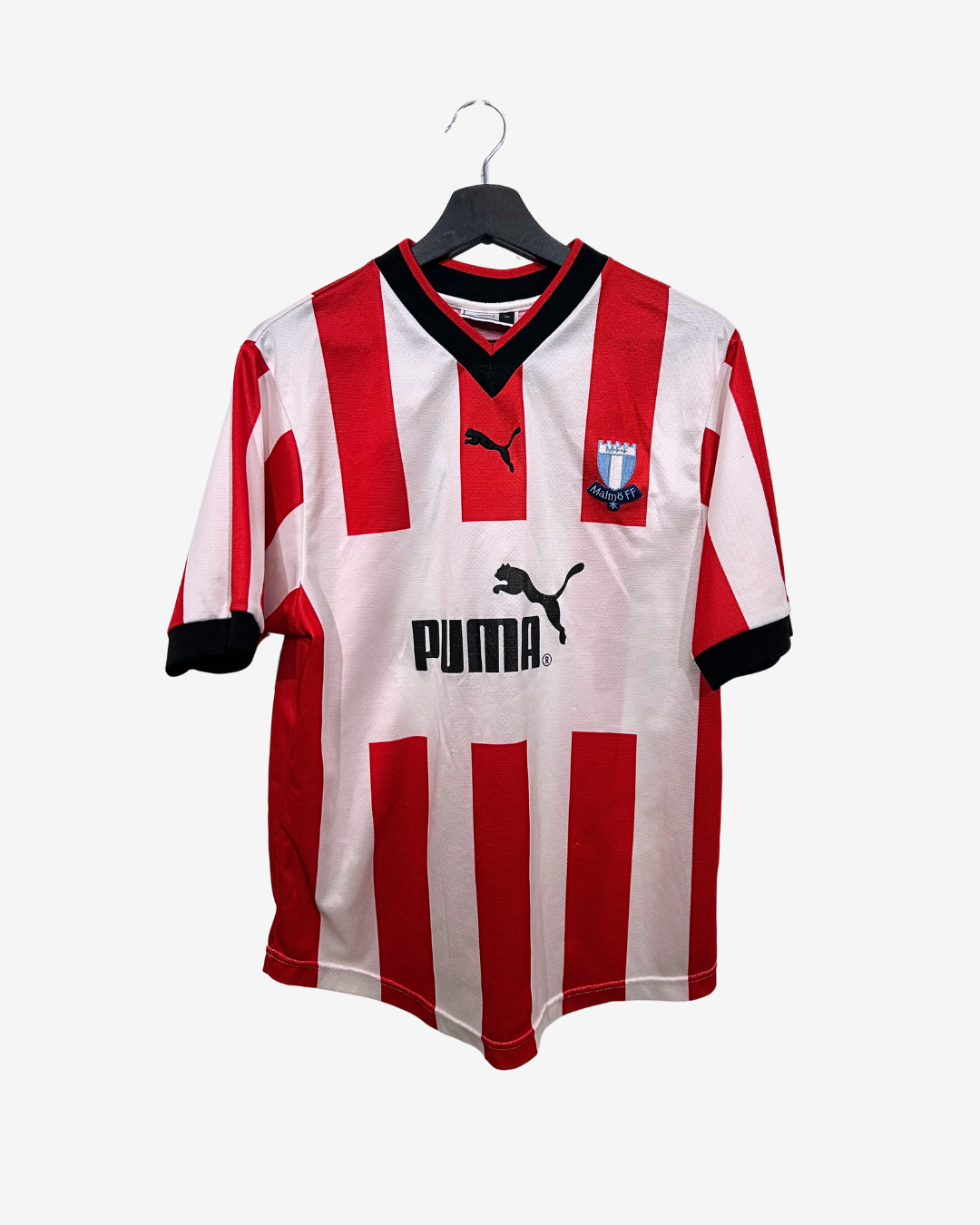 Red and white striped sports jersey with Puma logo on a hanger against a white background