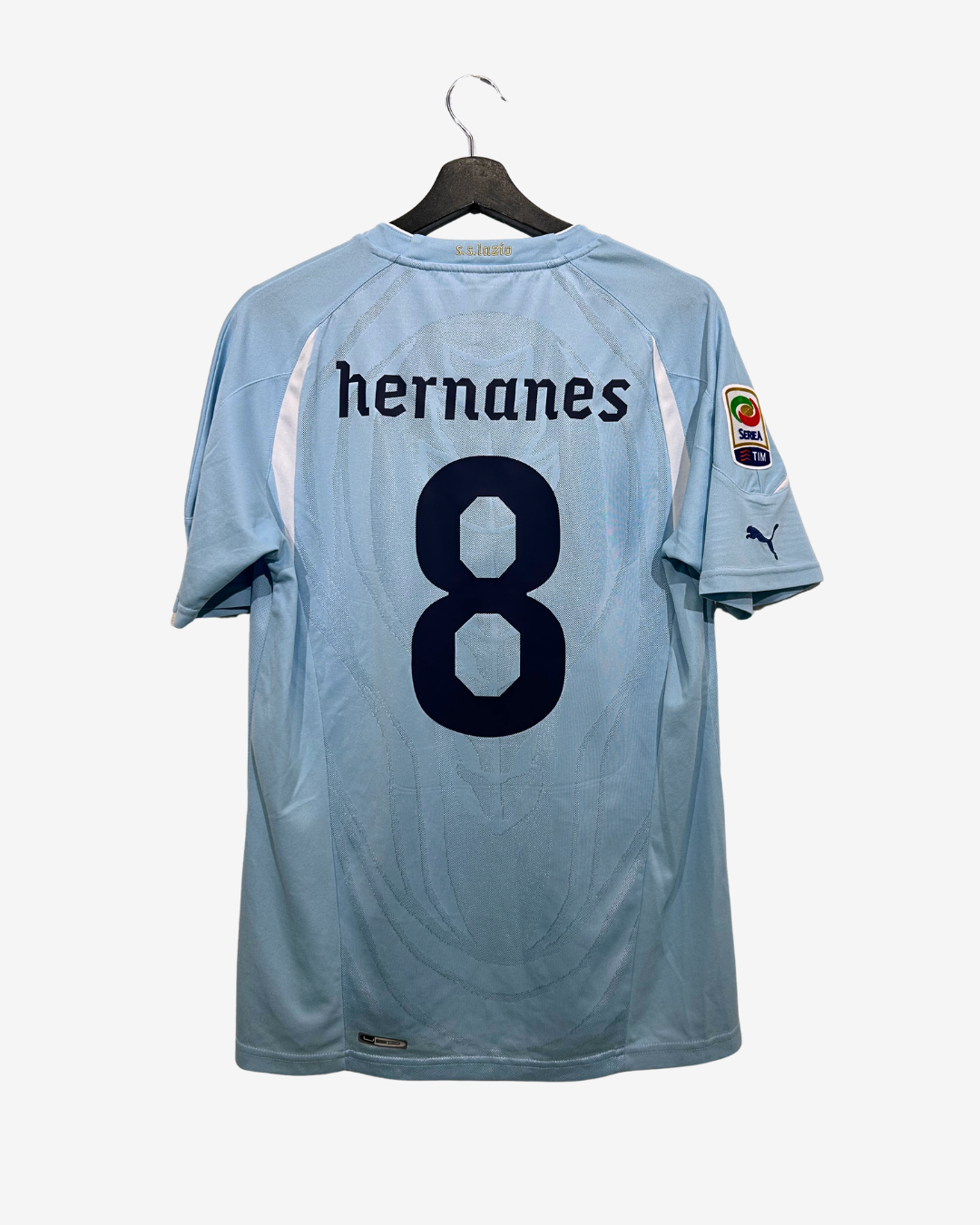 Light blue sports jersey with 'hernanes' and number '8' on a hanger against a white background