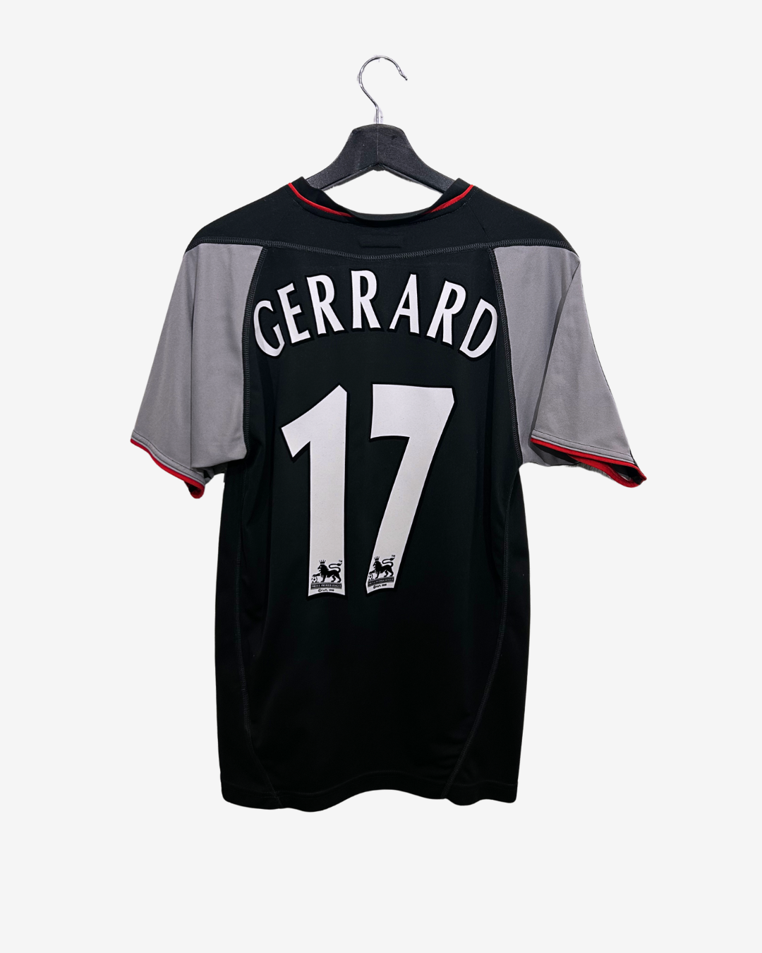 Black sports jersey with 'Gerrard 17' on a hanger against a white background