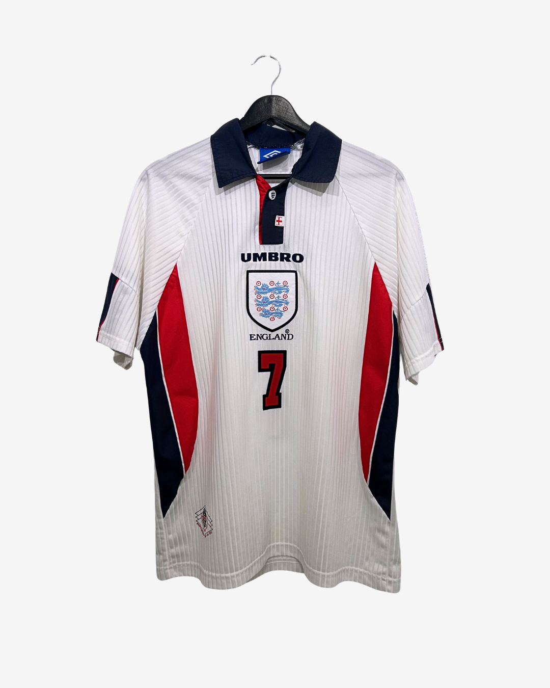 White sports jersey with red and black accents on a hanger against a white background