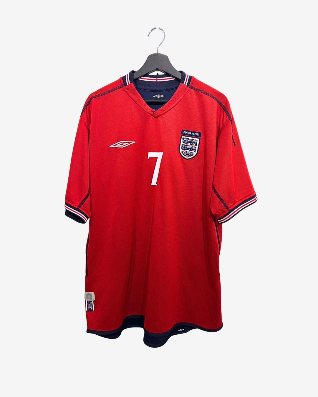 Red sports jersey with number 7 and England flag on a hanger against a white background