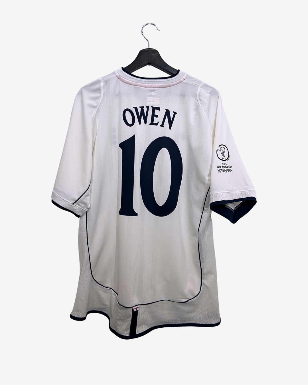 White sports jersey with 'Owen' and number '10' on a hanger against a white background
