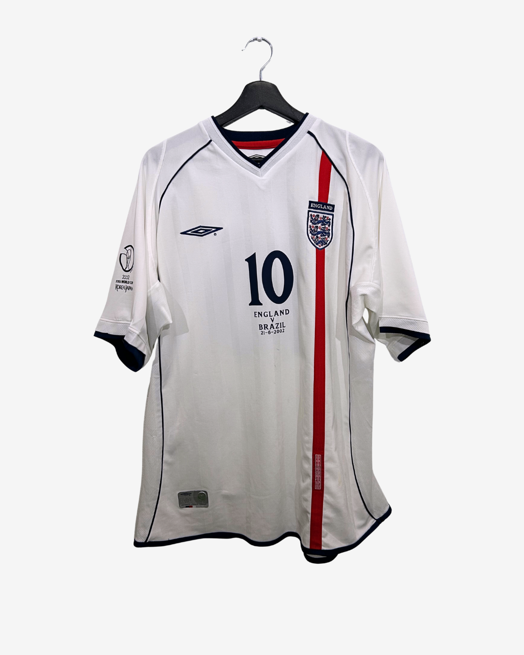 White sports jersey with red stripe and number 10 on a hanger against a white background