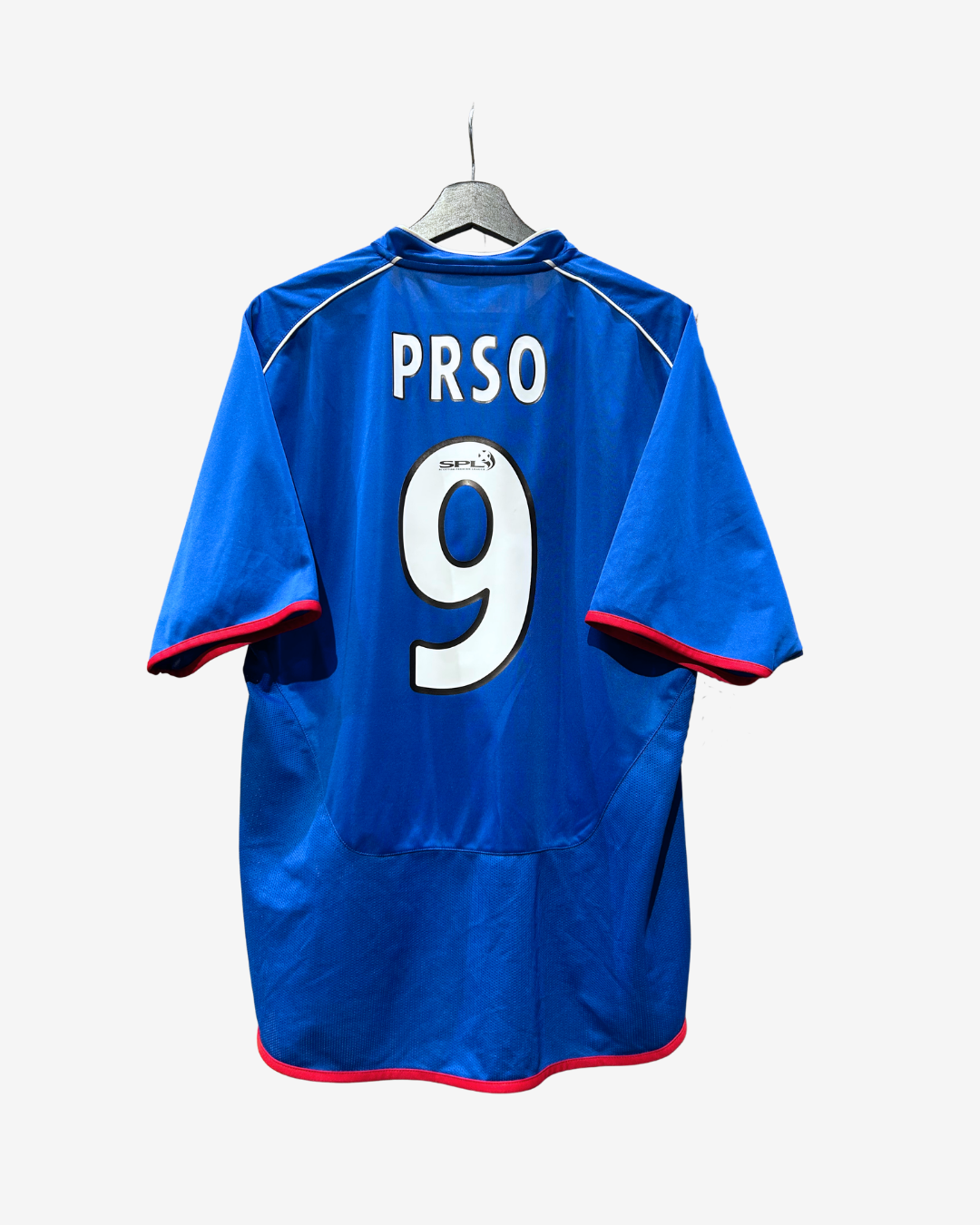A royal blue soccer jersey with 'PRSO' and the number '9' printed in white on the back, hanging on a gray hanger against a light gray background.