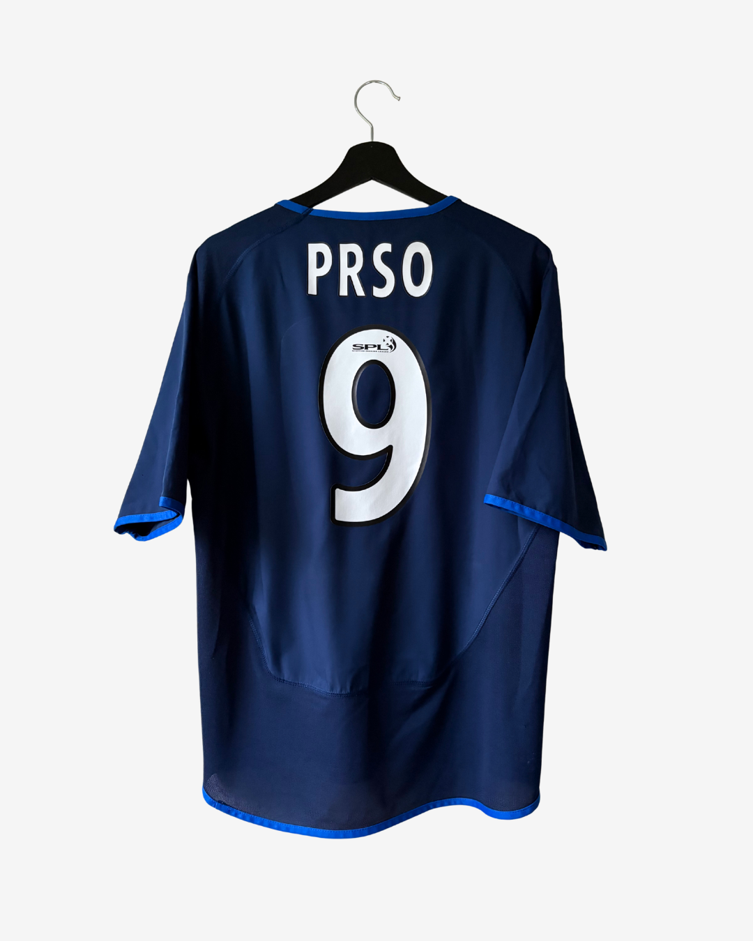 A navy blue Tangers FC soccer jersey with the name 'PRSO' and number '9' printed on the back, hanging on a black hanger against a light gray background.