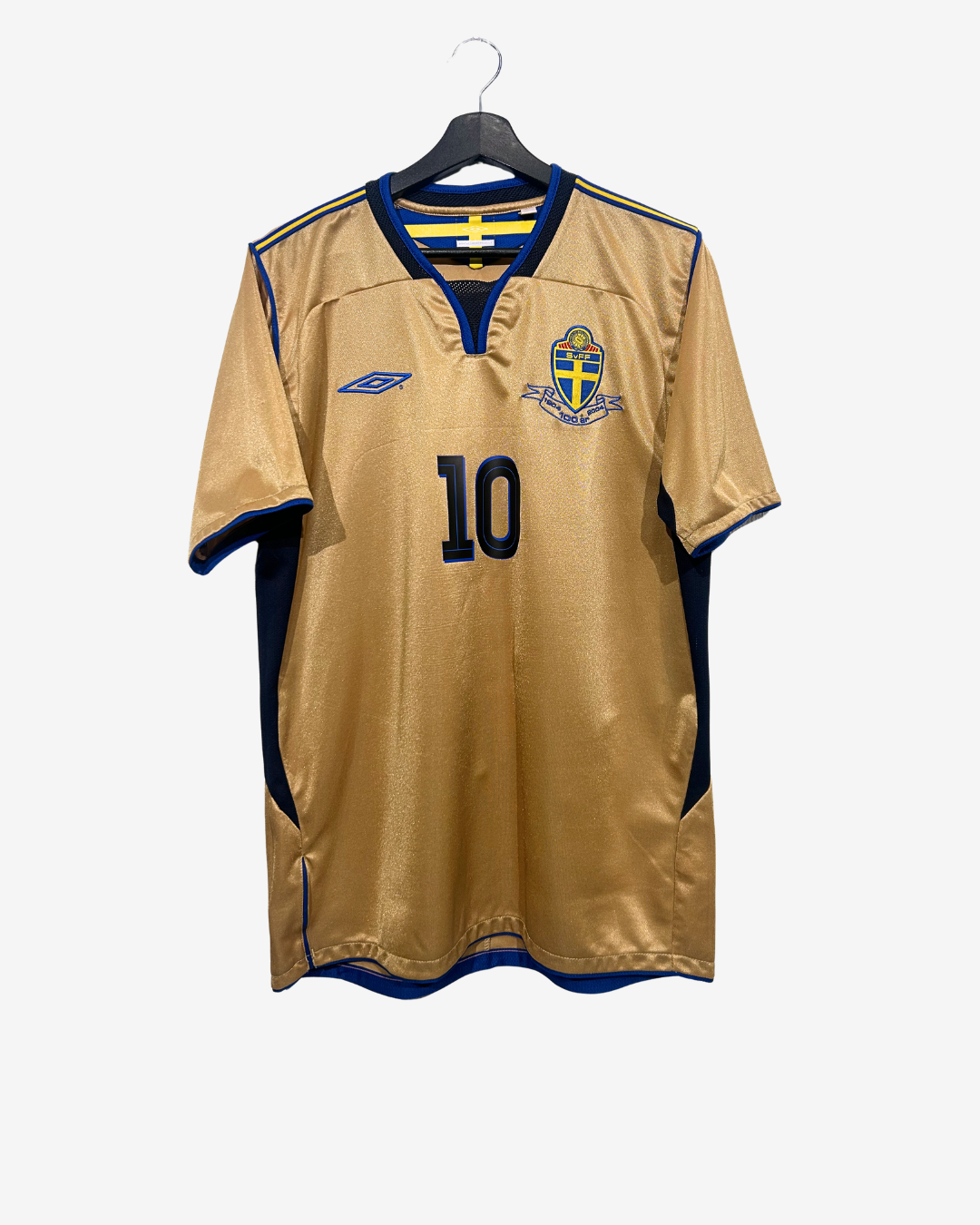Gold sports jersey with number 10 on a hanger against a white background