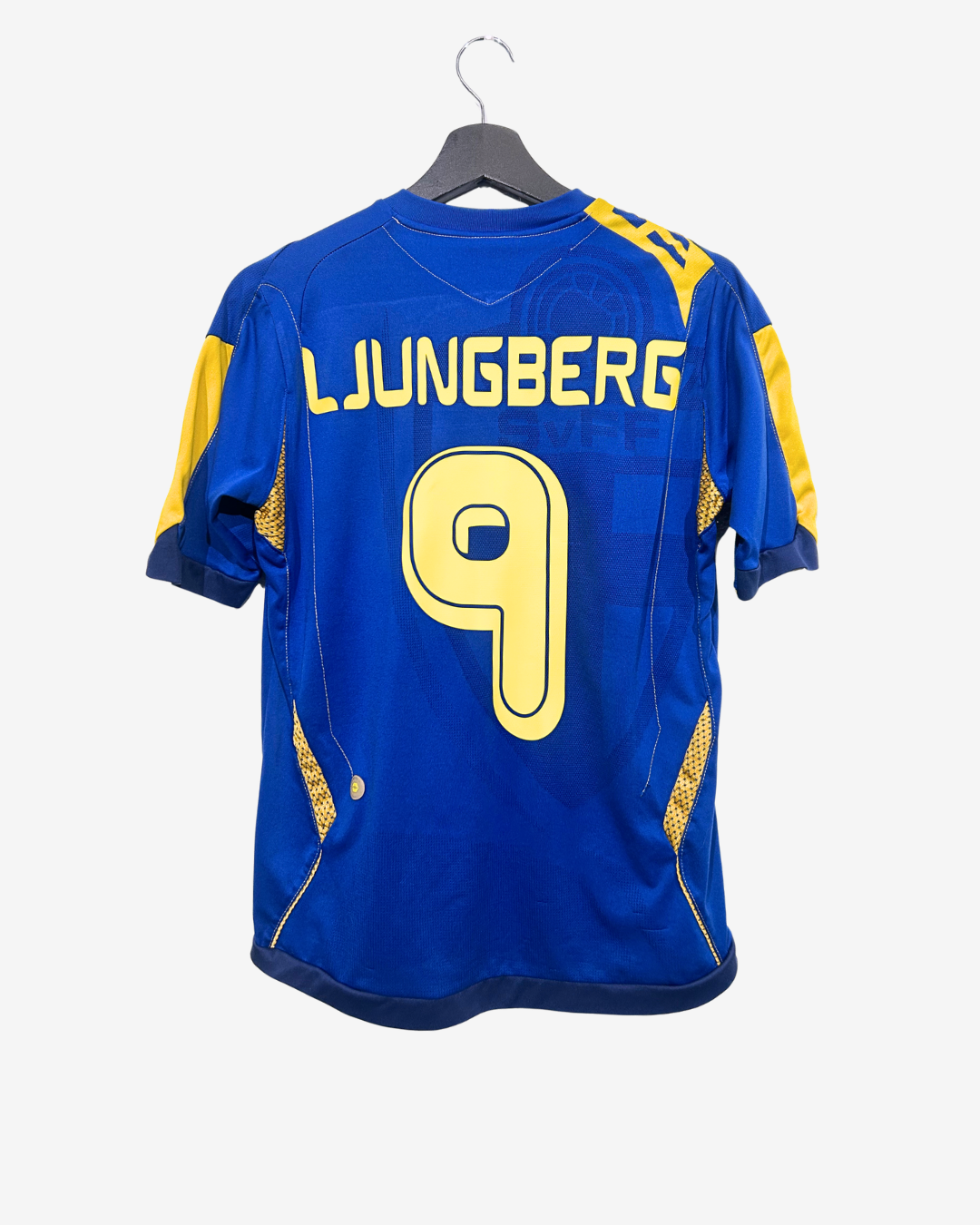 Blue sports jersey with yellow lettering and number on a hanger