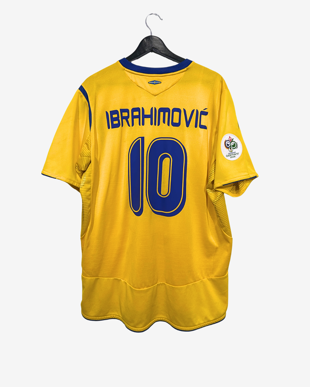 Yellow sports jersey with 'Ibrahimovic' and number '10' on a hanger against a white background