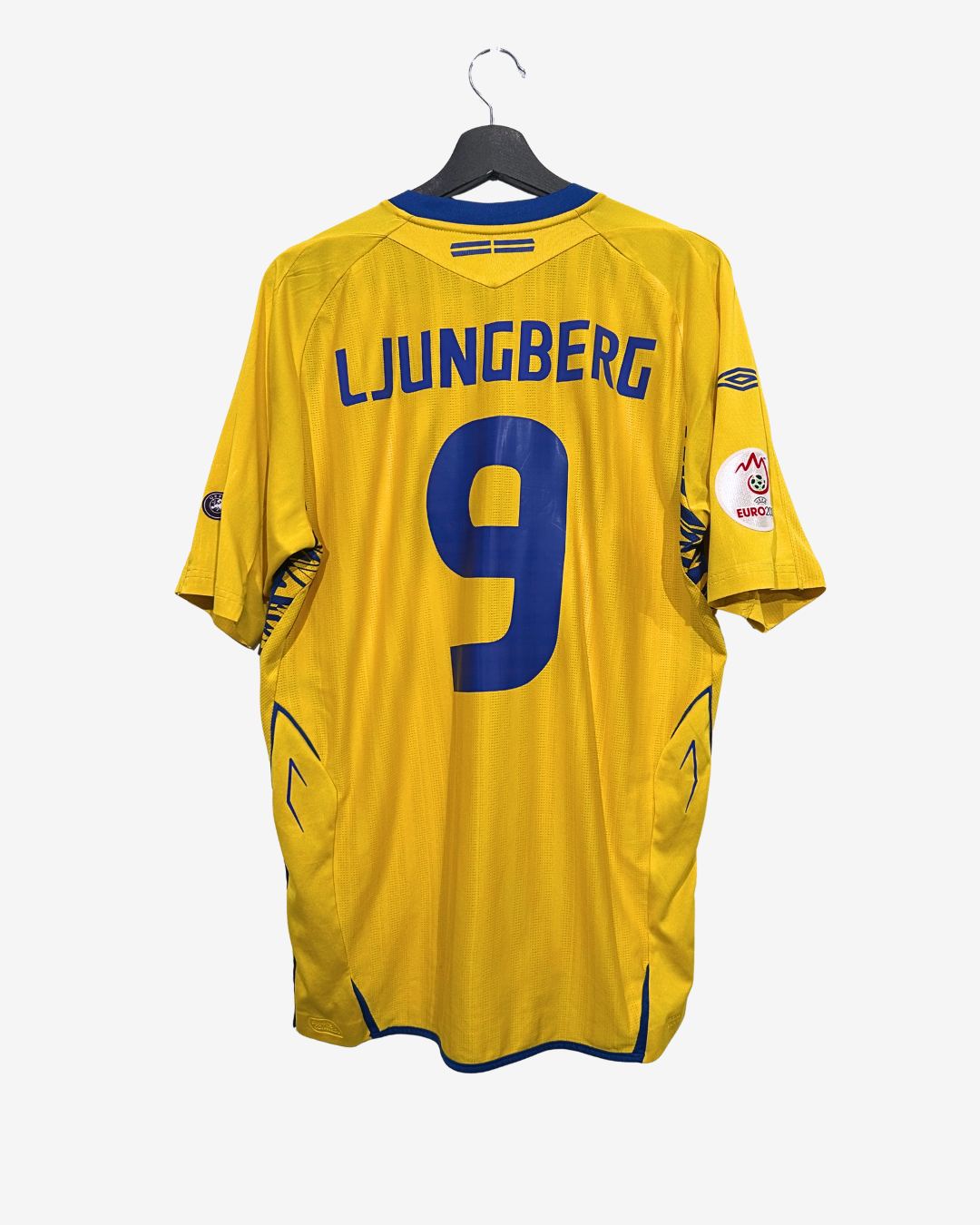 Yellow sports jersey with 'LJUNGBERG' and number '9' on a hanger against a white background