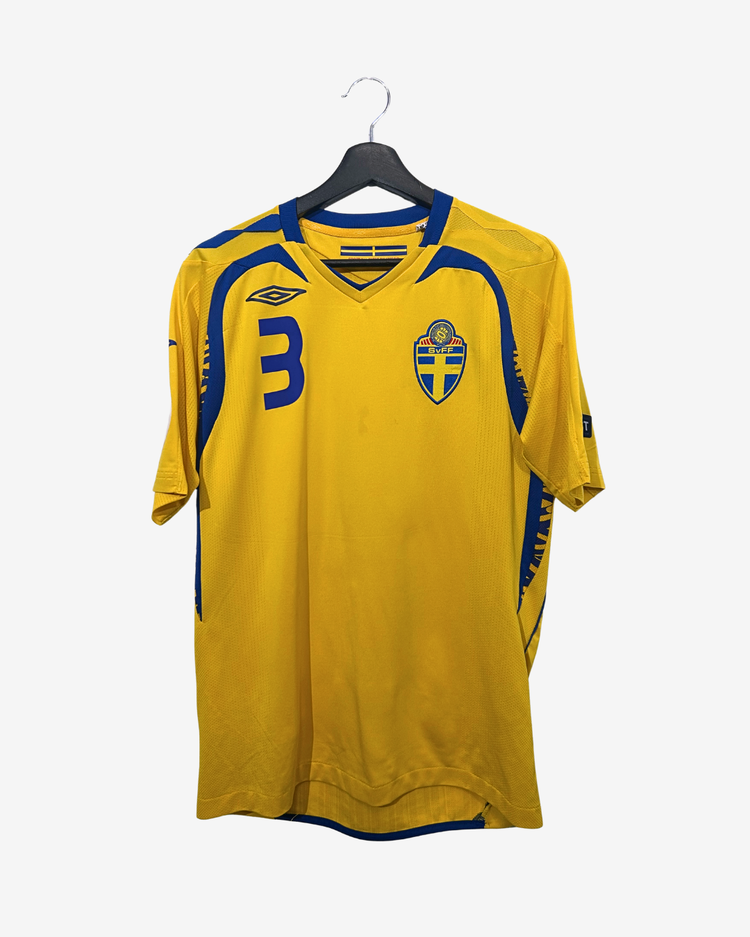 Yellow sports jersey with blue accents on a hanger against a white background