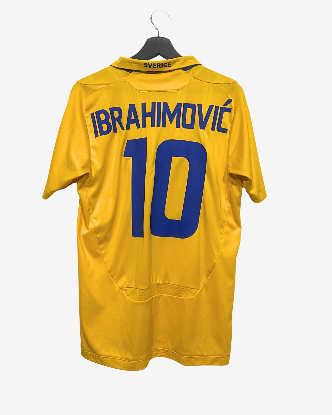 Yellow sports jersey with 'Ibrahimovic' and number '10' on a hanger against a white background