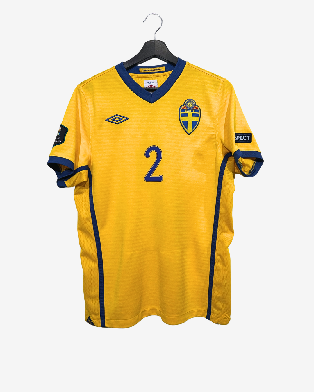 Yellow sports jersey with blue accents on a hanger against a white background