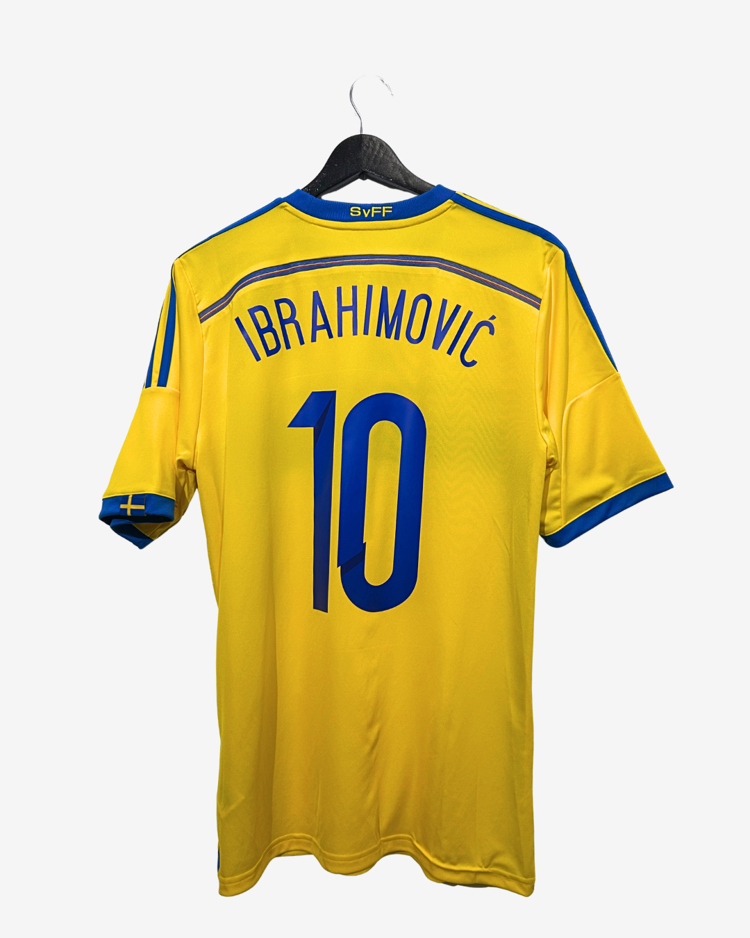 Yellow sports jersey with 'Ibrahimovic' and number '10' on a hanger against a white background
