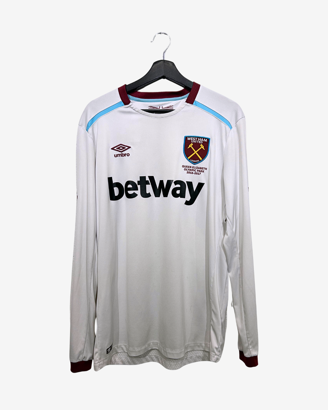 White sports jersey with branding on a hanger against a white background
