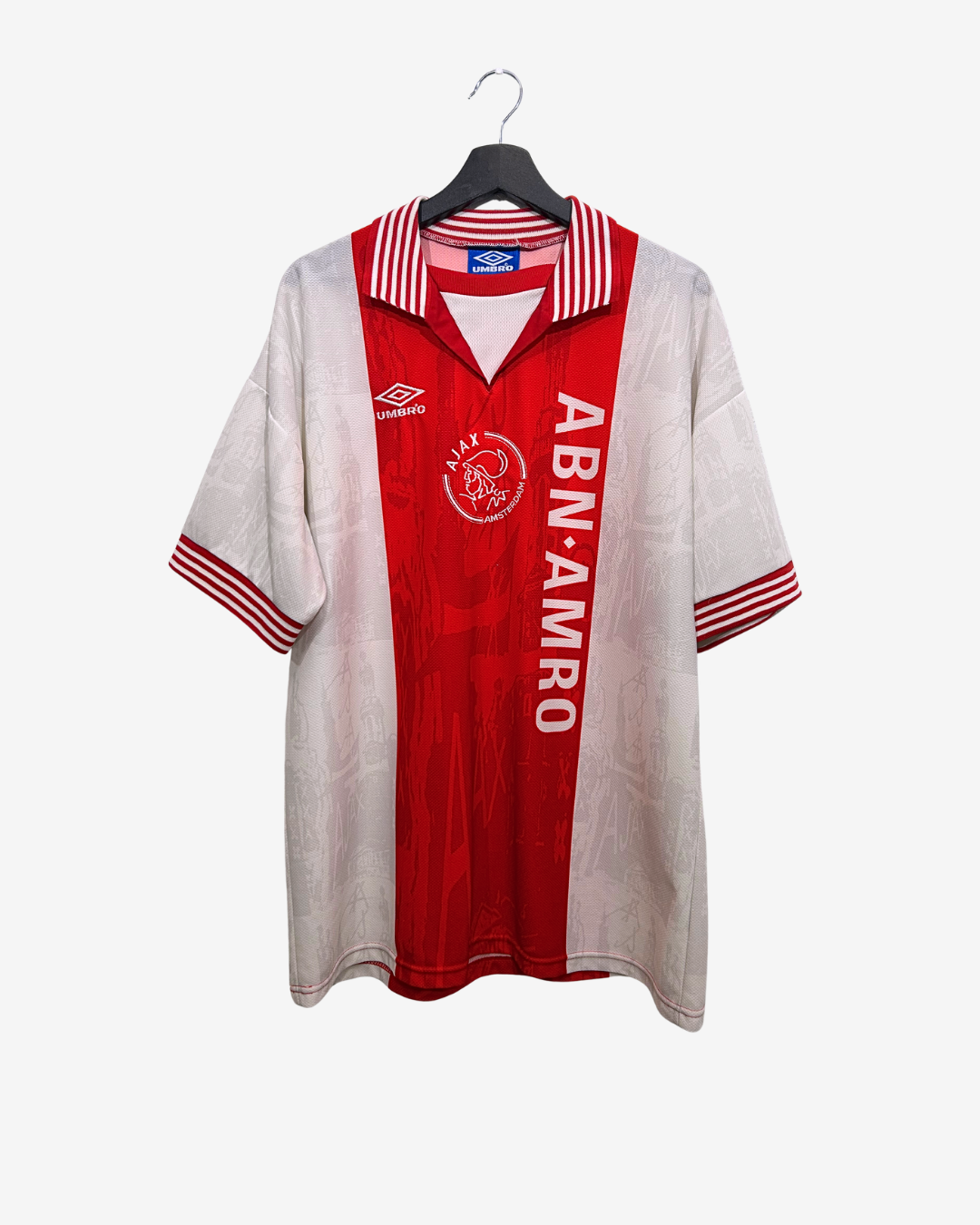 Red and white sports jersey with visible branding on a hanger against a white background